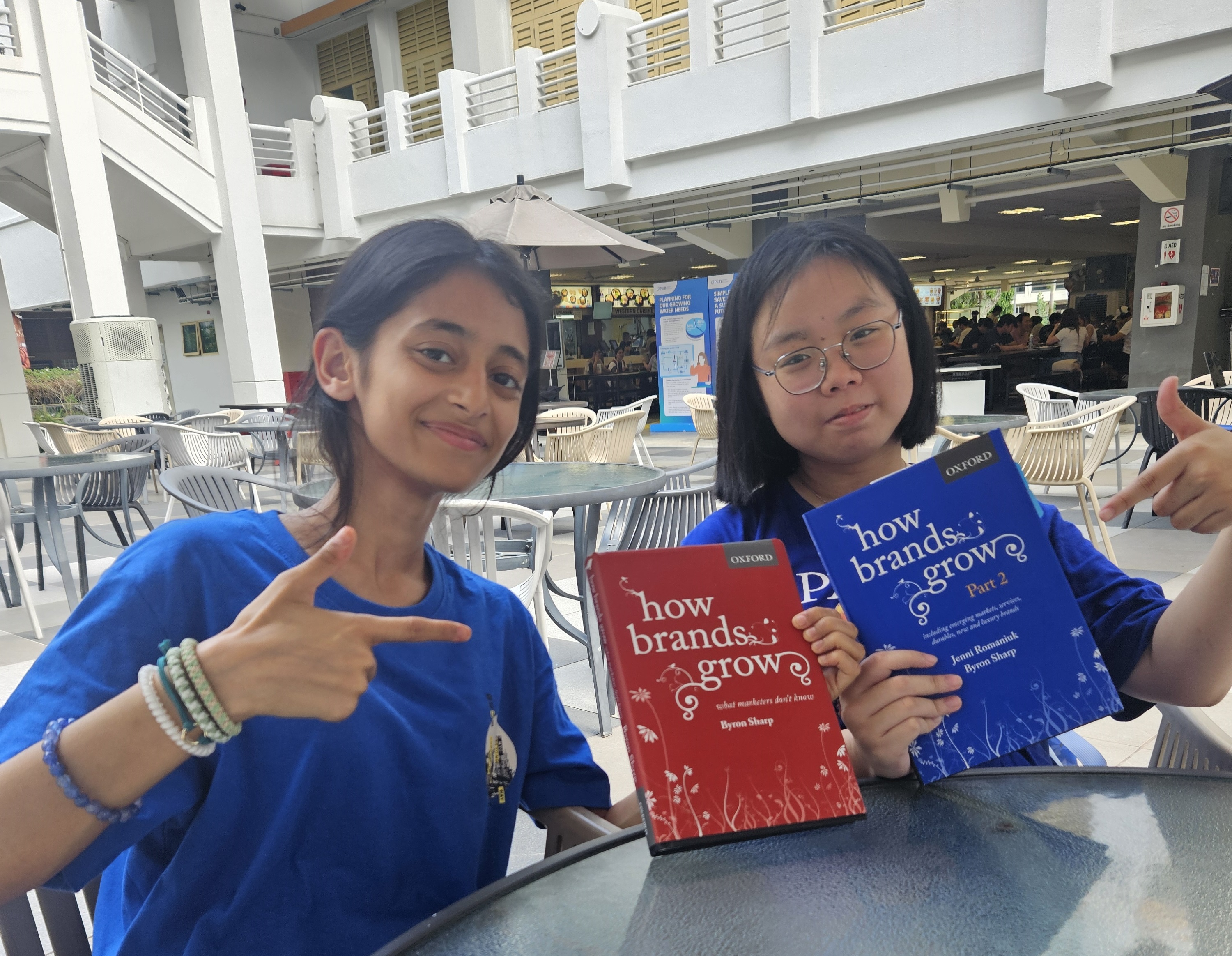 Anayana and Marcella with the book “How Brands Grow” by Byron Sharp and Jenni Romaniuk – given to them by Dr Hafihz to help prepare them for the competition.