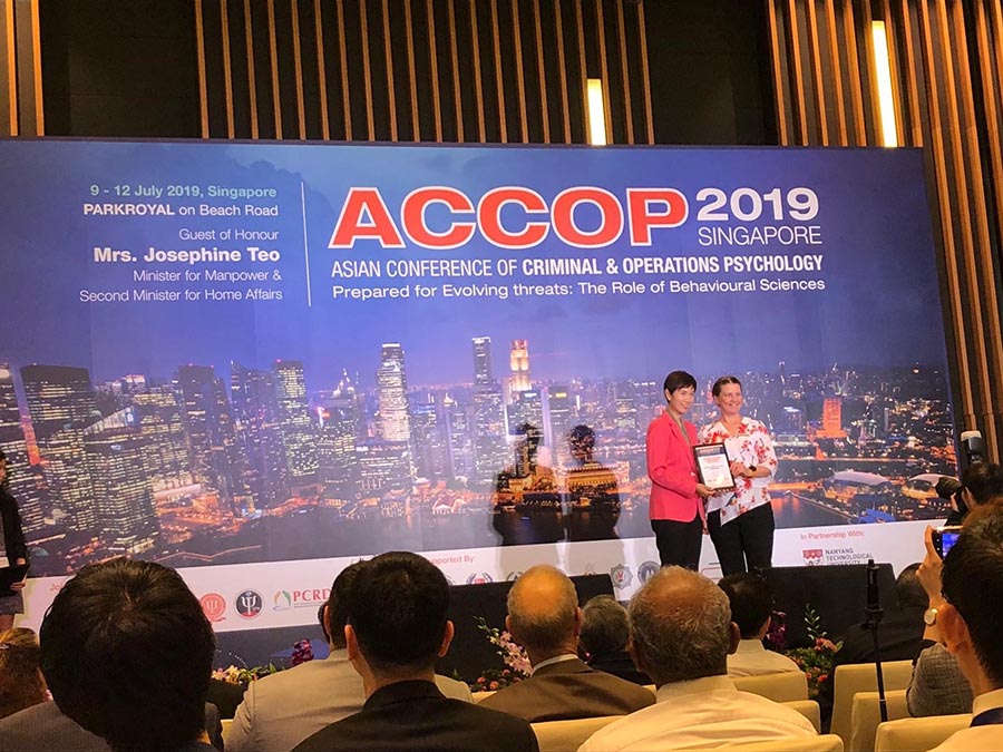 Dr Denise Dillon accepting award on JCU's behalf from the Guest-of-Honour — Minister for Manpower & Second Minister for Home Affairs, Mrs Josephine Teo