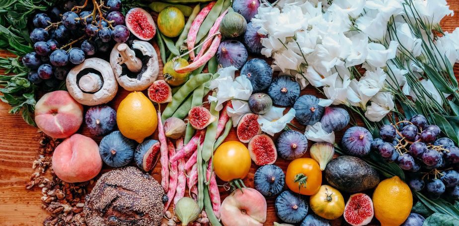 Fruits, Vegetables, and Flowers on a Table